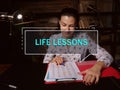 LIFE LESSONS text in block of quotes. Modern Banker doing paperwork AÃÂ lesson which conveys something instructive or valuable Royalty Free Stock Photo